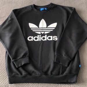 Adidas sweatshirt. Crew neck with pockets. Classic black & white logo design.